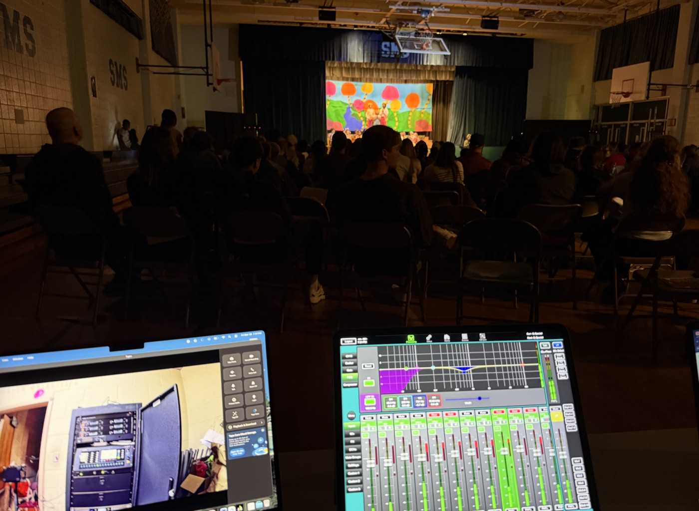 Mixing console and laptop setup during a school musical production