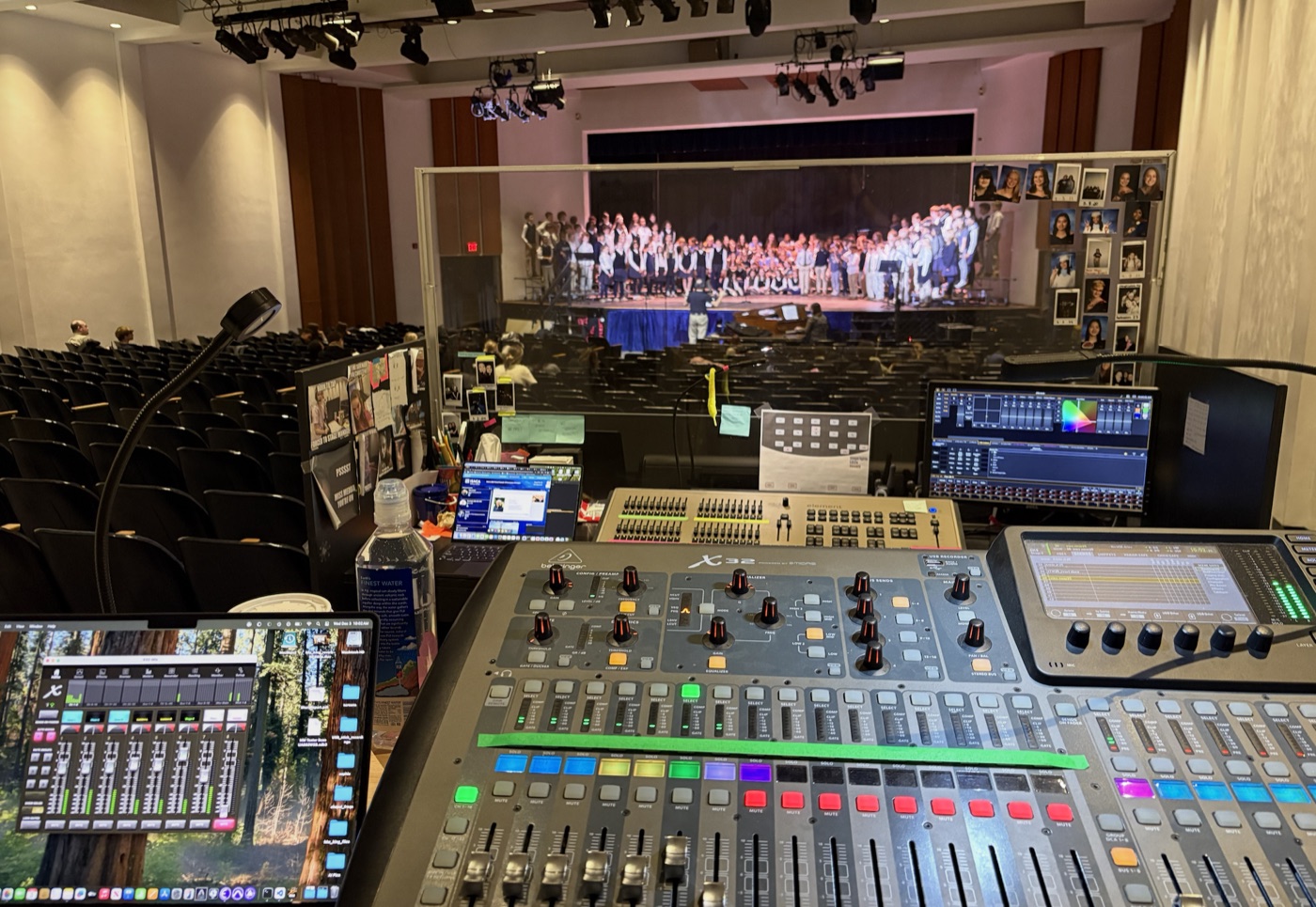 Full production mix position with multiple screens and digital console in theater venue