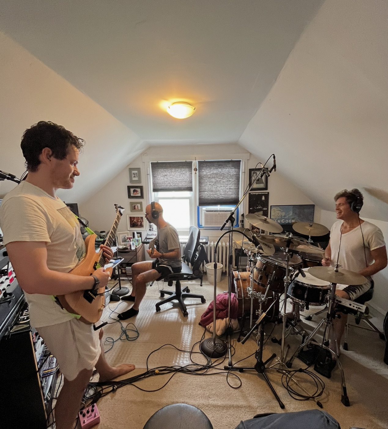 Band tracking session in the studio — guitar, bass, and drums